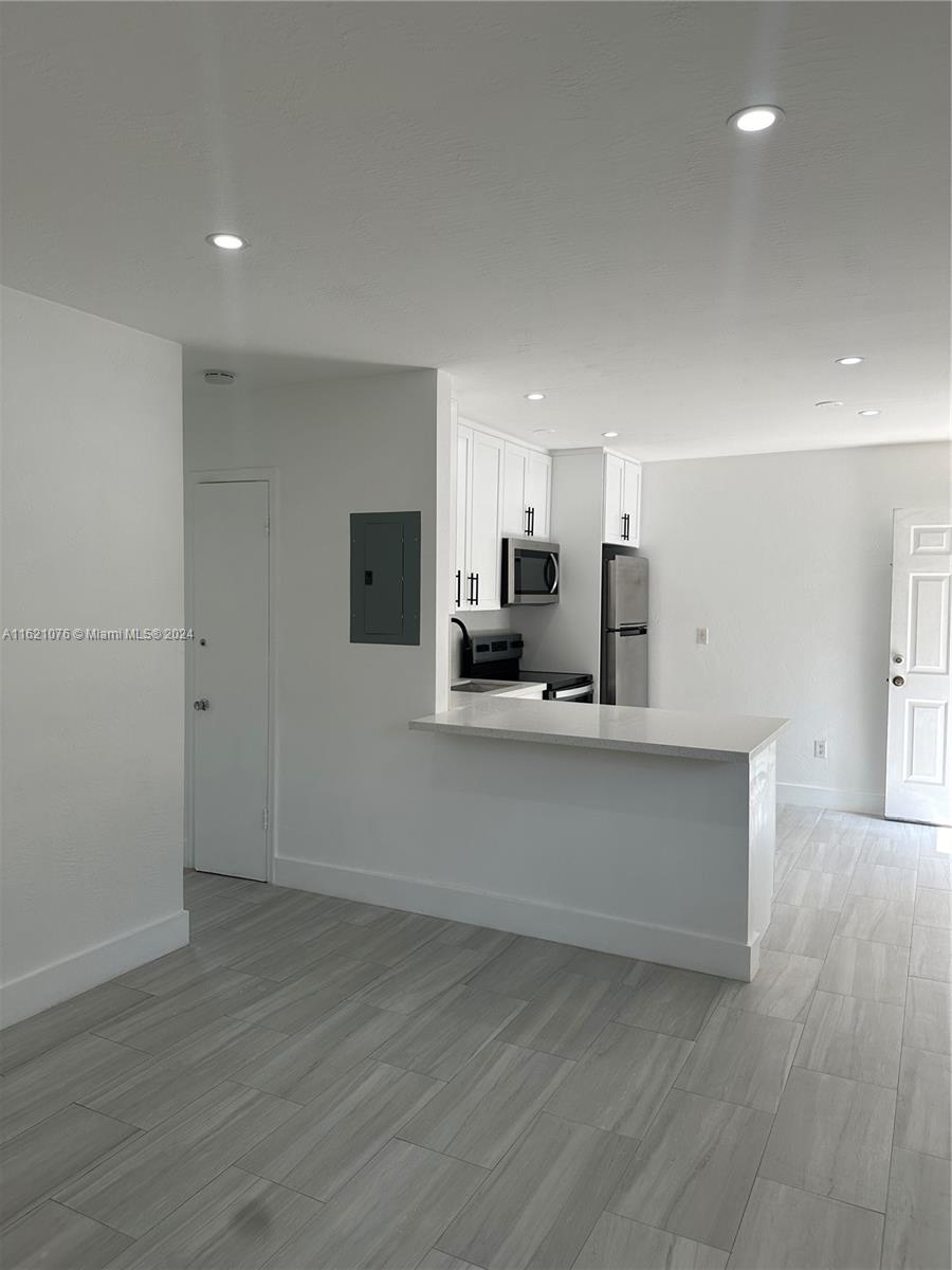 a view of kitchen with wooden floor