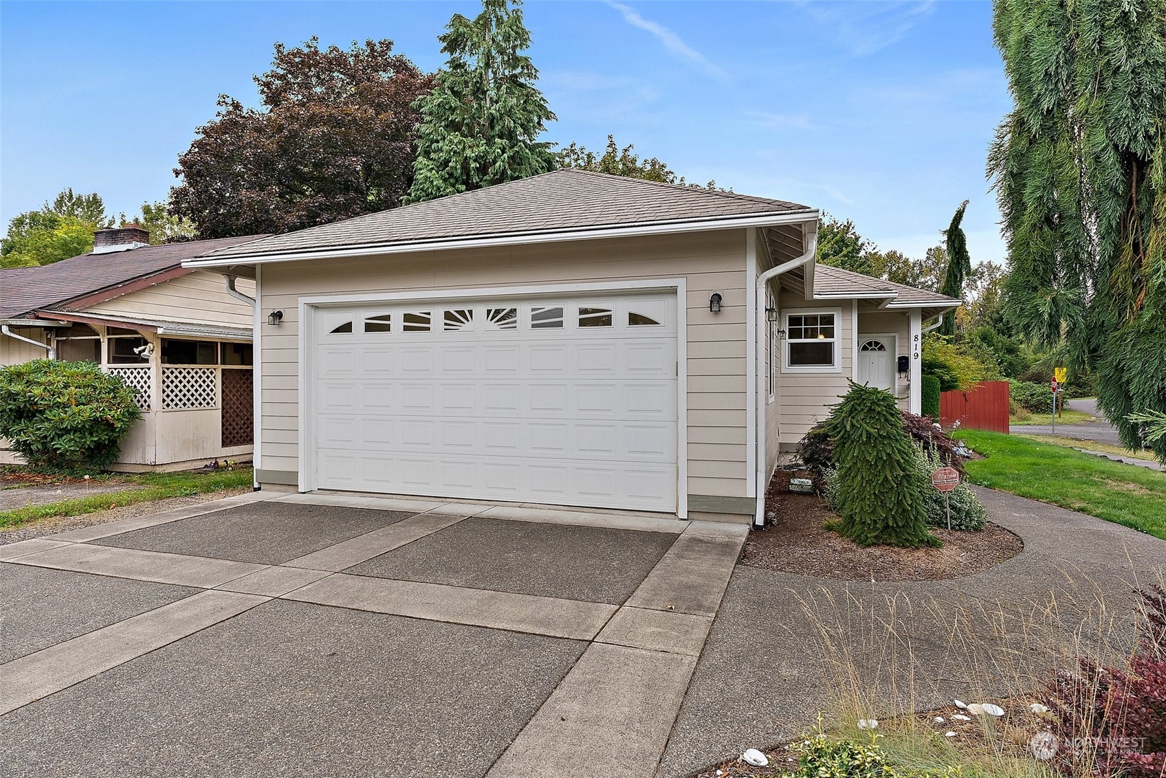 a front view of a house with a yard and garage