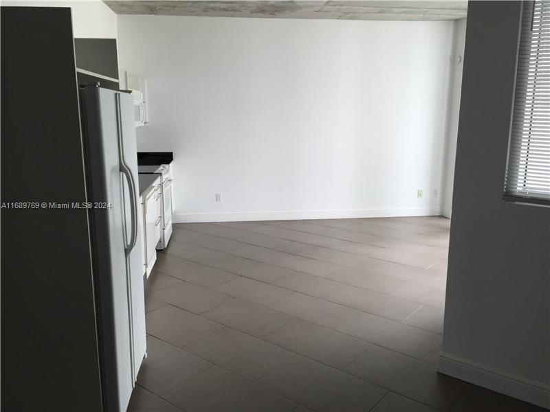 a view of a hallway with a refrigerator