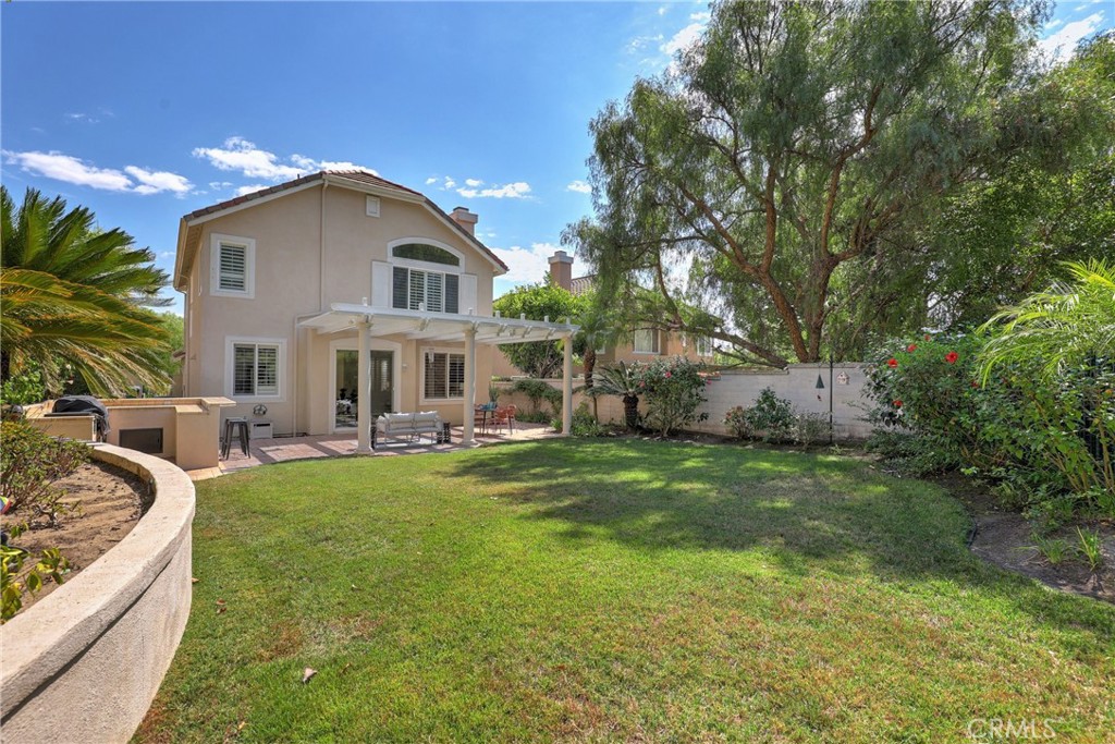 a view of house with backyard and outdoor seating