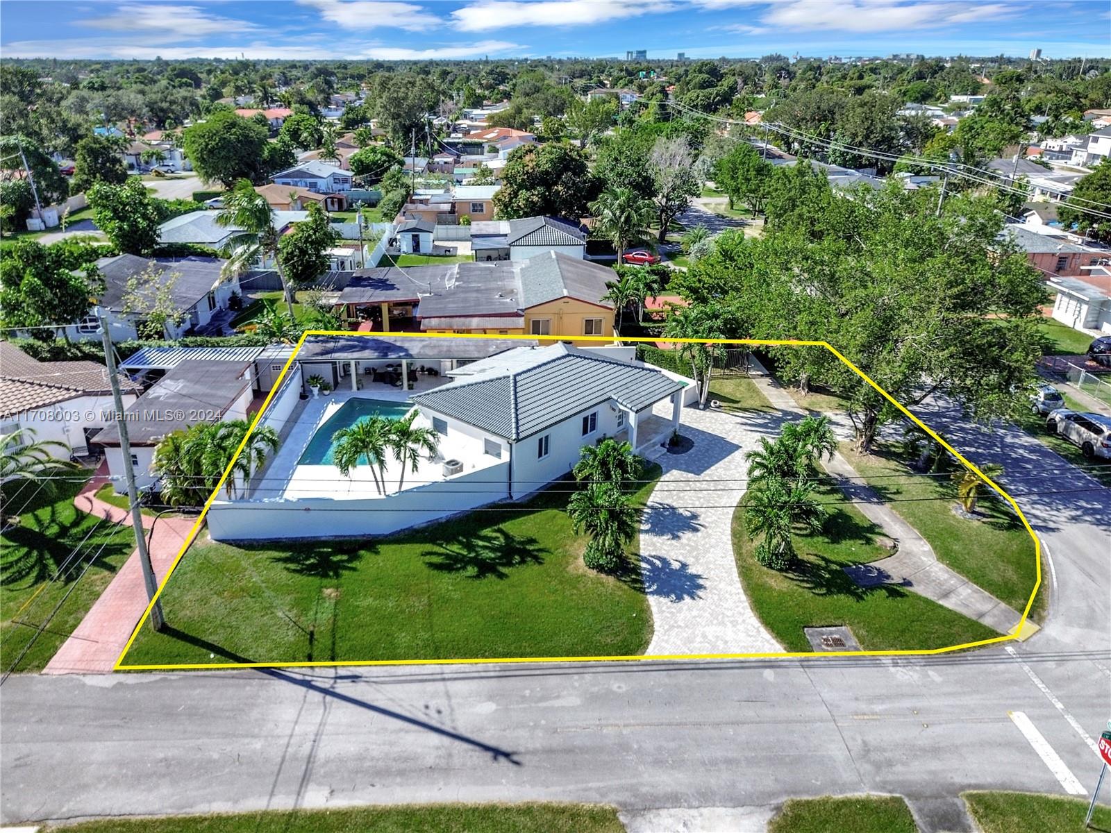 an aerial view of a house with a yard and lake view