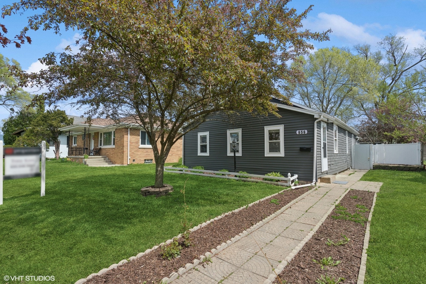 a front view of a house with a garden