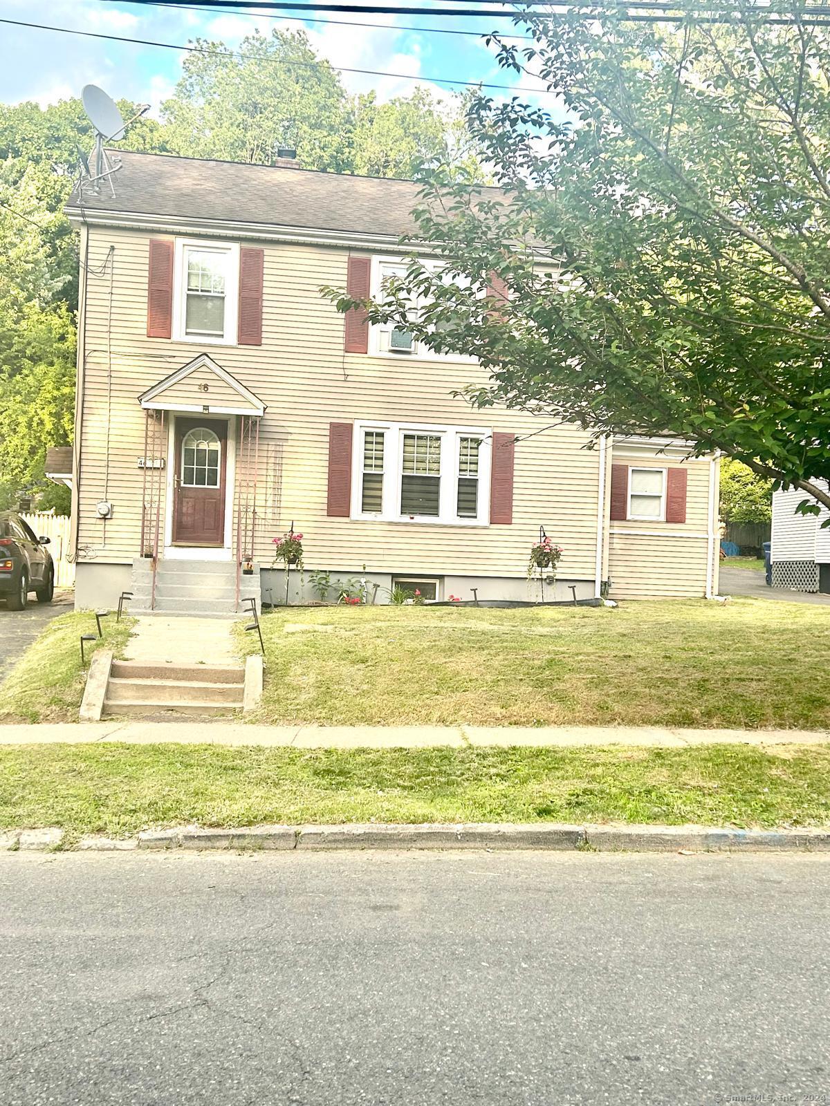 a front view of a house with a swimming pool