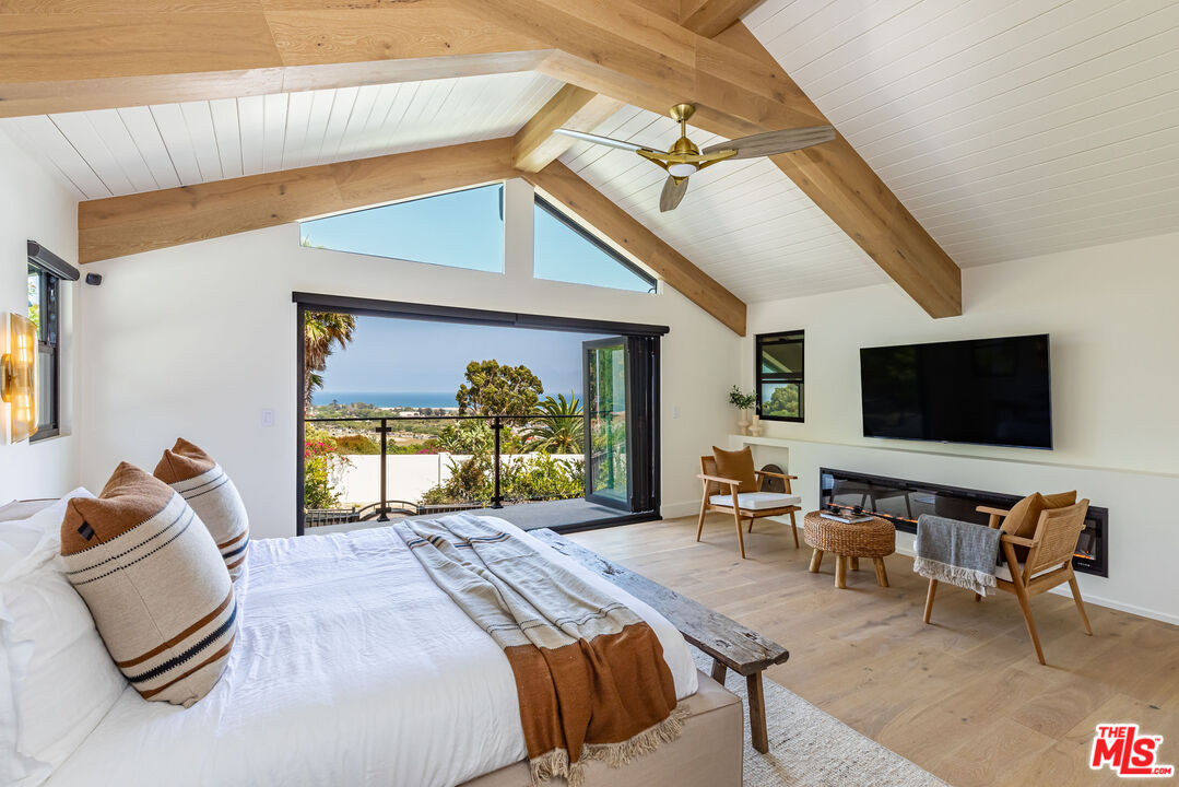 a bedroom with furniture and a flat screen tv