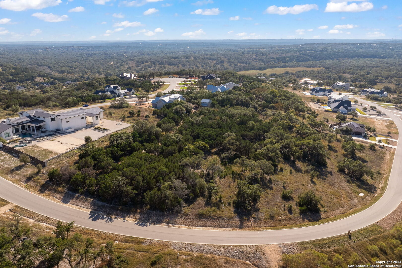 an aerial view of residential houses with outdoor space