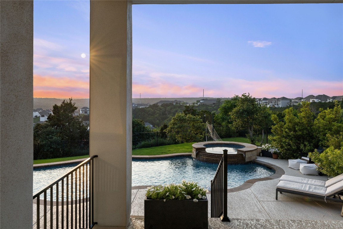 a view of a patio with lawn chairs fire pit and a yard