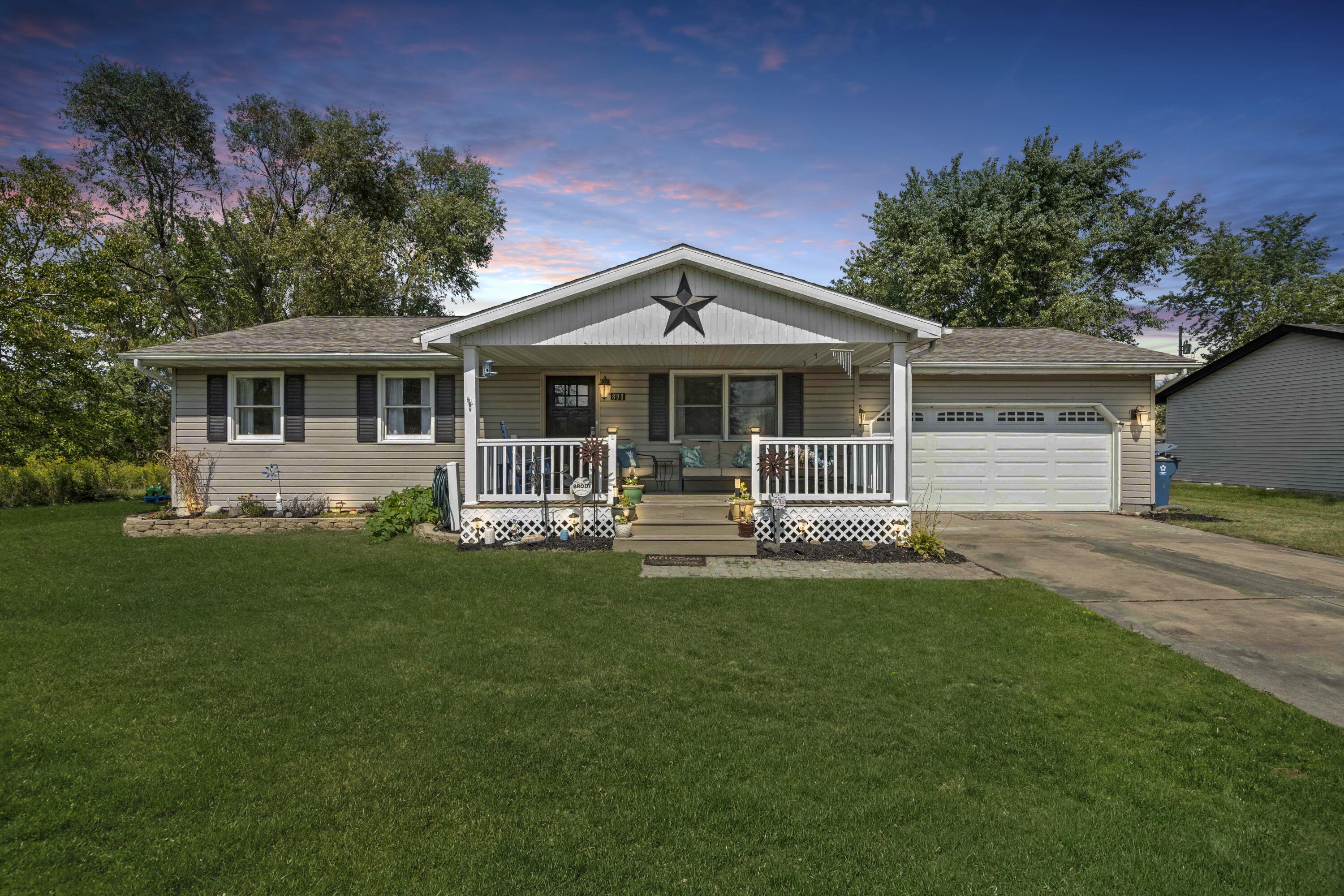 a front view of a house with a garden