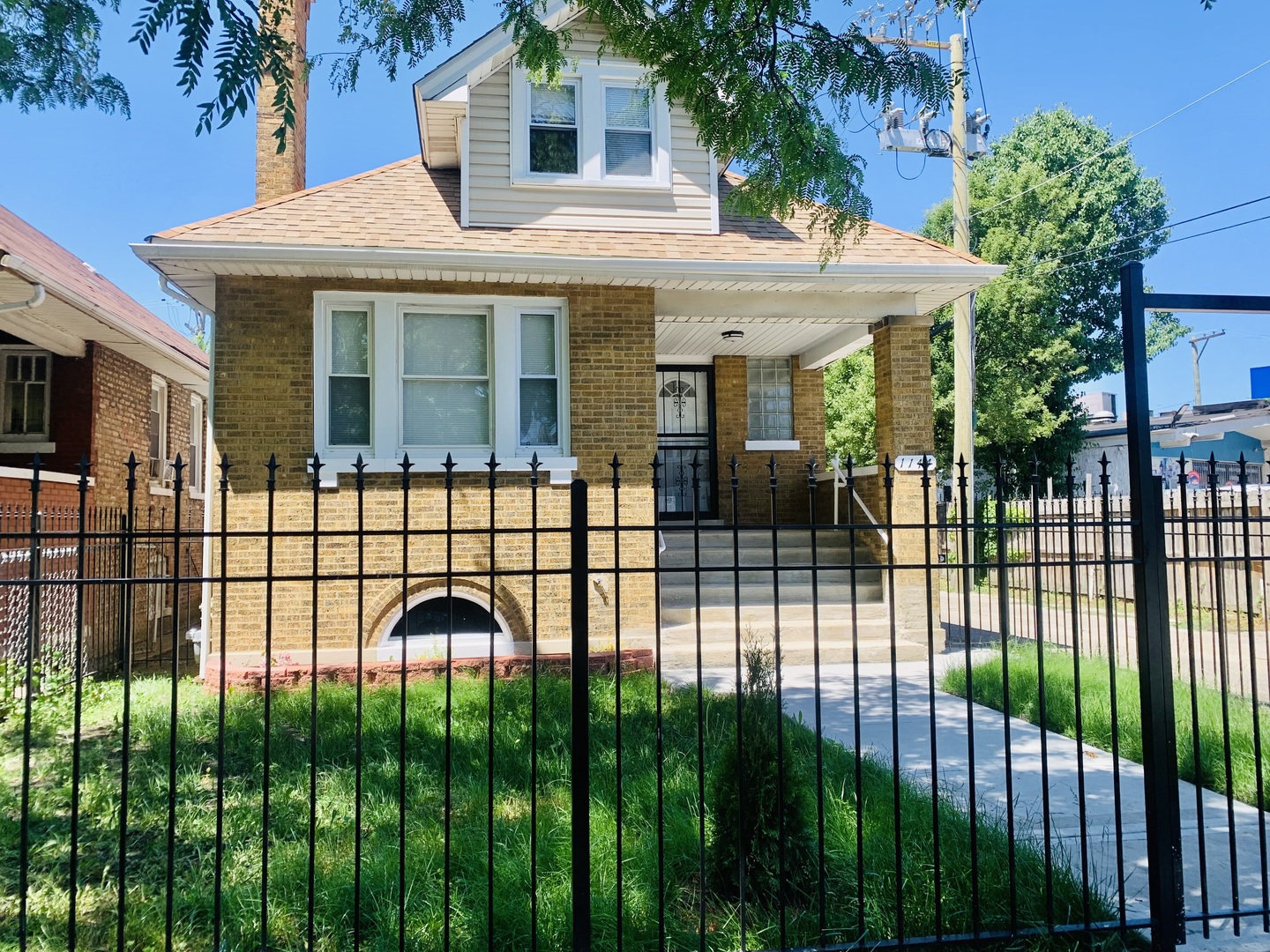 a view of a house with a iron fence