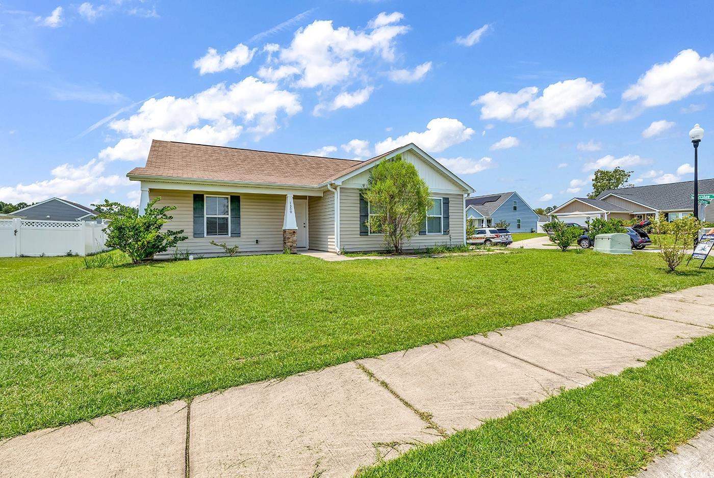 Ranch-style house featuring a front yard