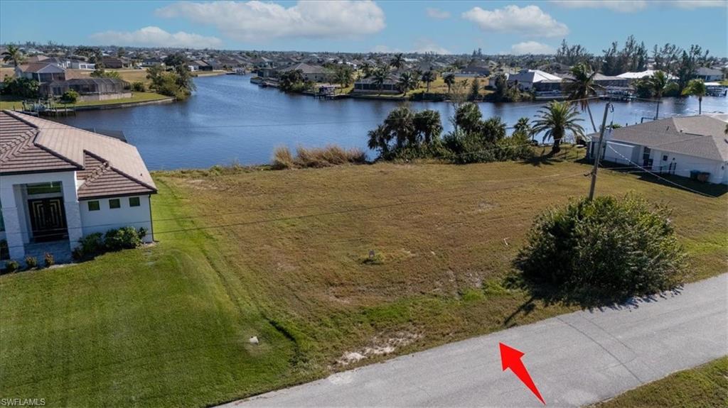 Birds eye view of property with a water view