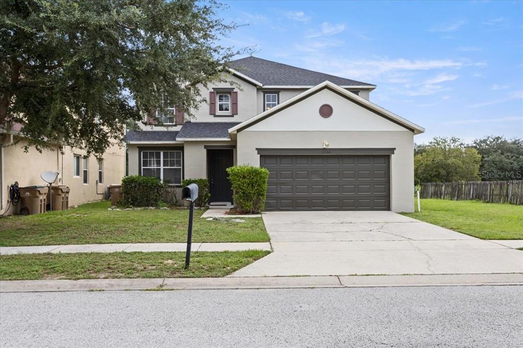 a front view of a house with a yard and garage