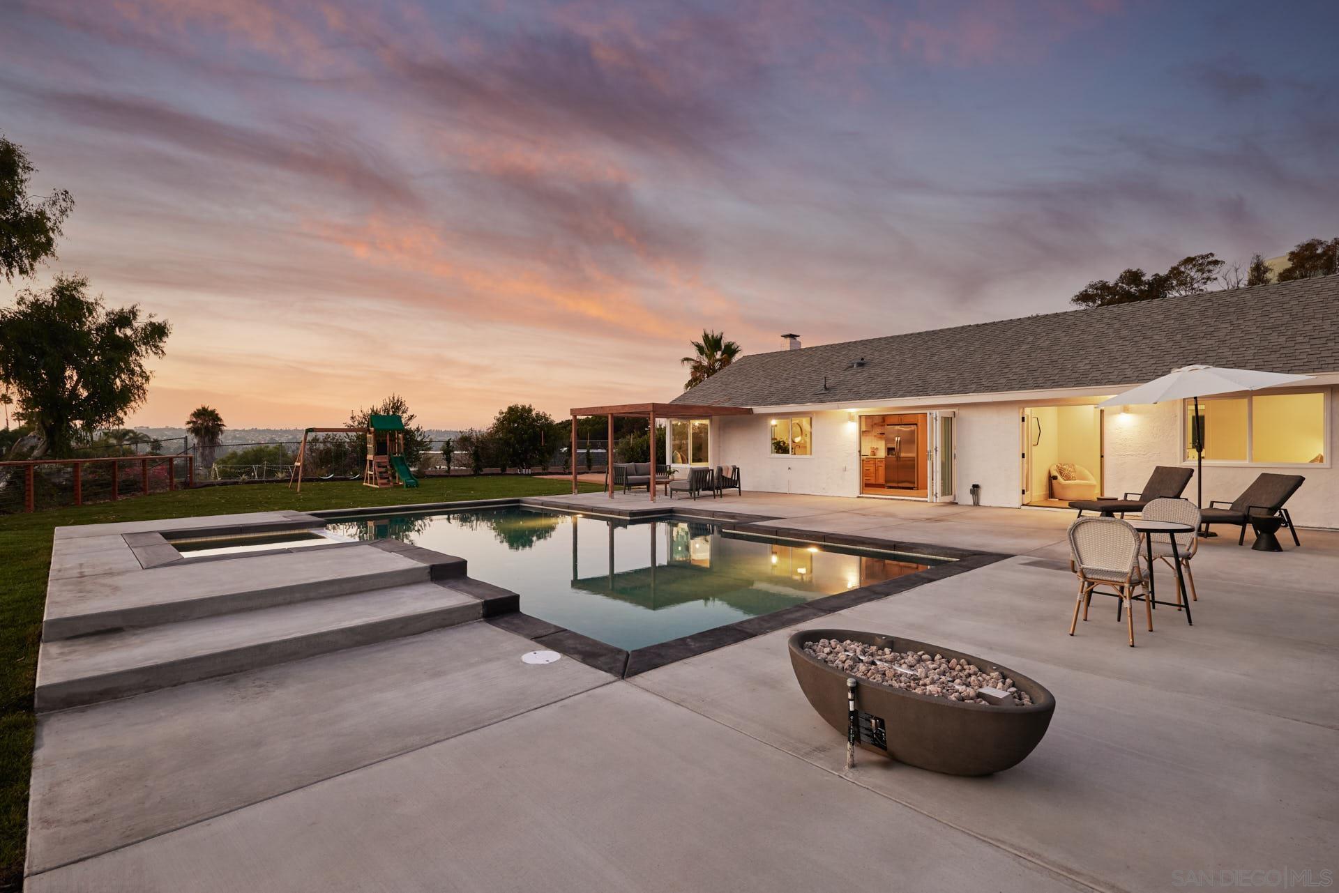 a roof deck with couches and potted plants