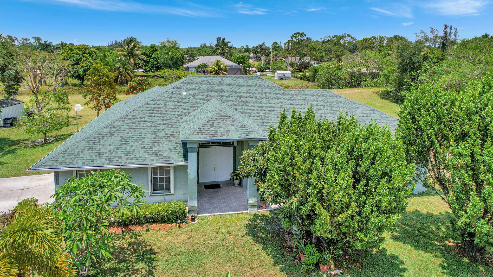 an aerial view of a house with a yard and lake view