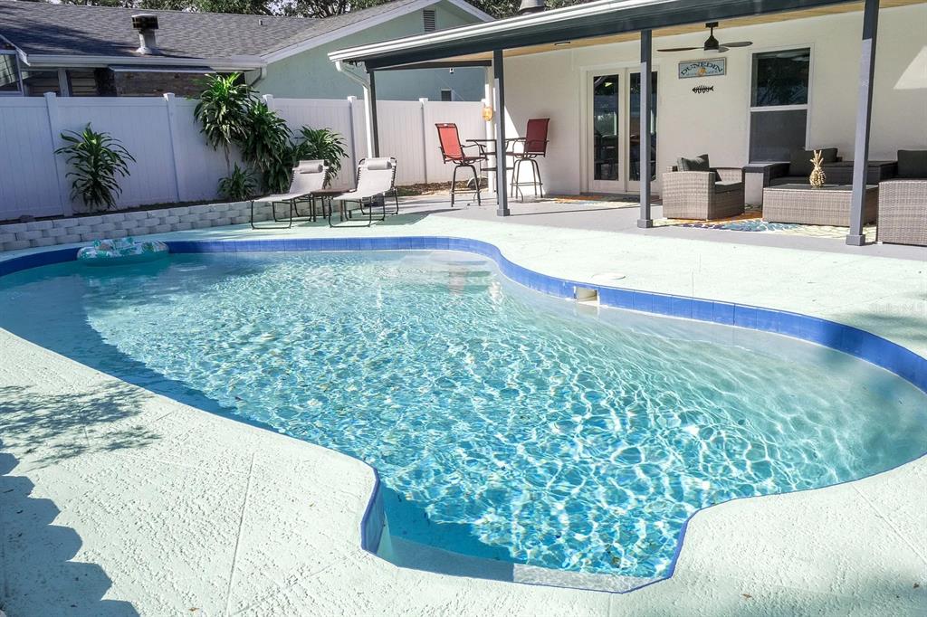 a view of swimming pool with outdoor seating