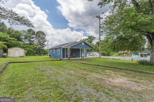 a front view of house with yard and green space