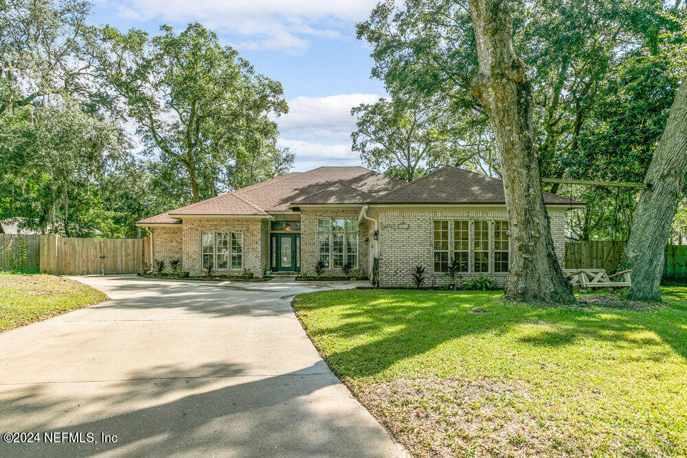 a view of a house with a yard and sitting area