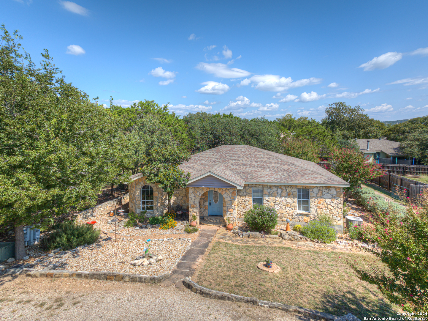 a front view of a house with a yard and mountain view