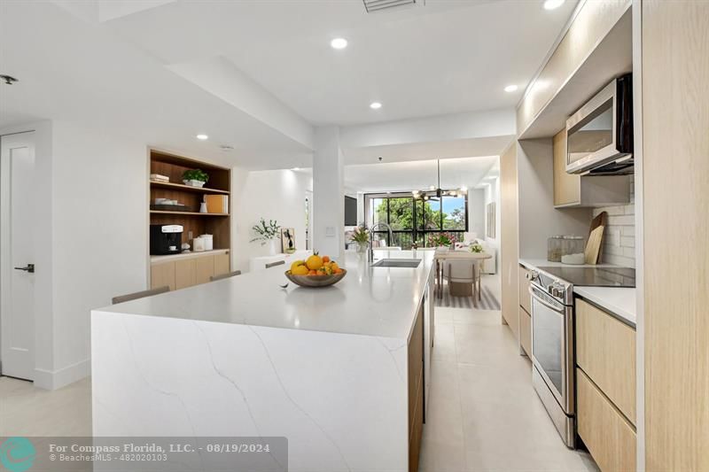 a kitchen with sink refrigerator and stove