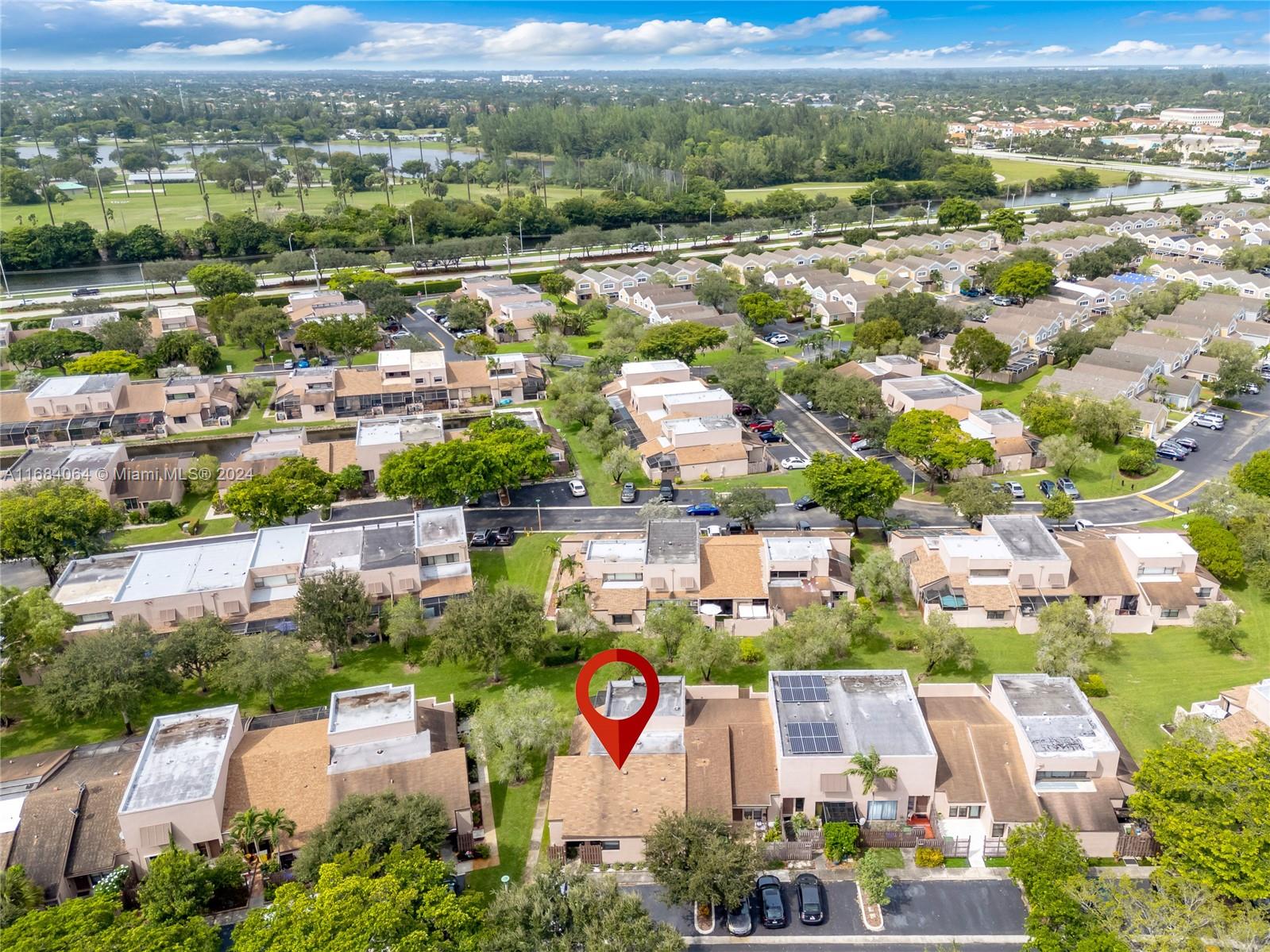 an aerial view of residential houses with outdoor space and river