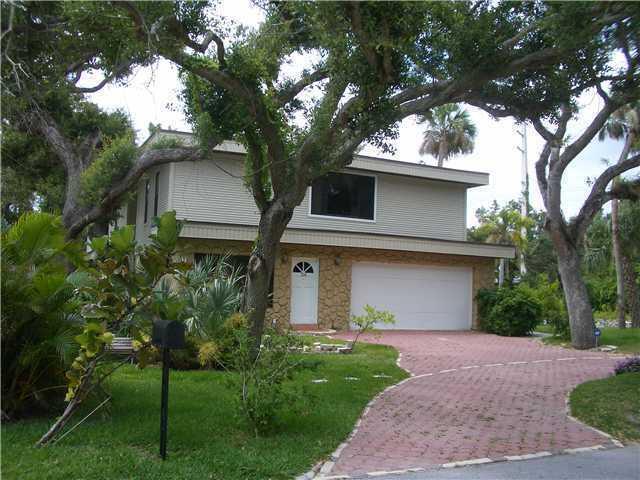 a front view of house with a garden