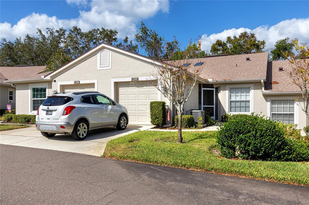 a view of front a house with a yard and garage