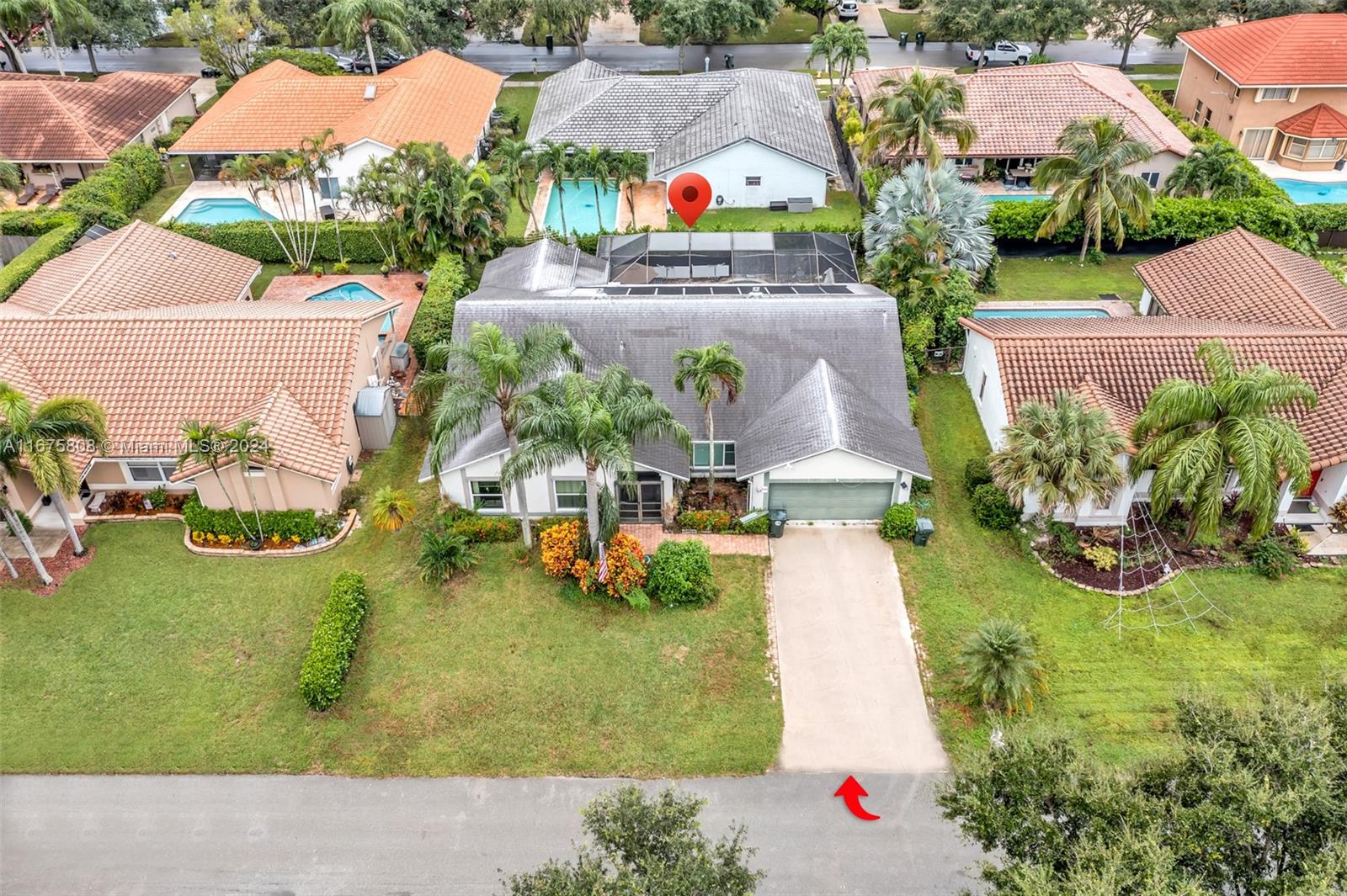 an aerial view of a house with a garden and swimming pool