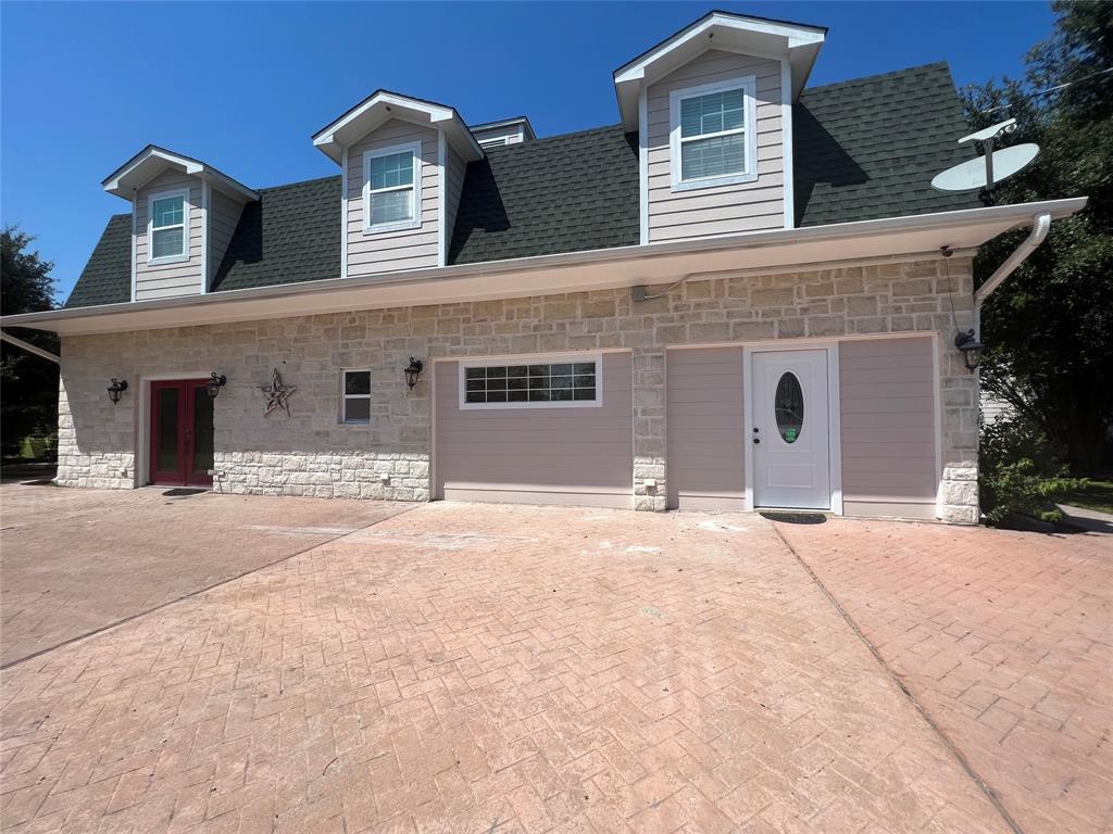 front view of a house with a yard and a garage