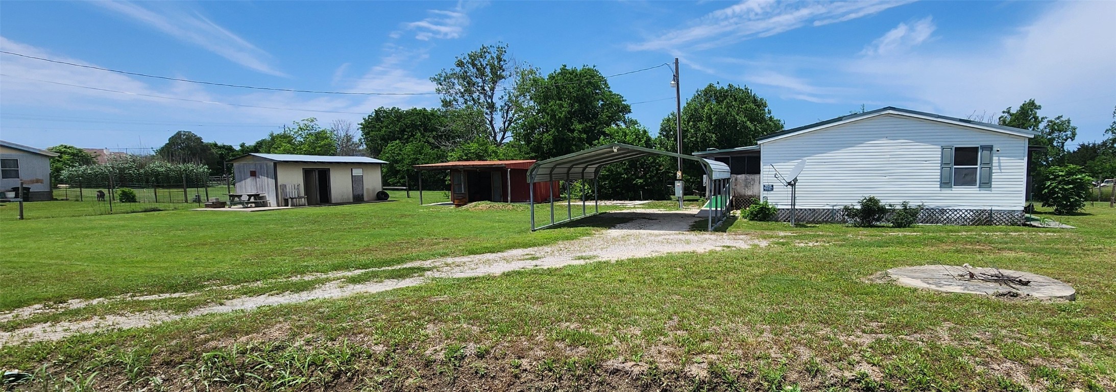 a view of a house with backyard and a tree