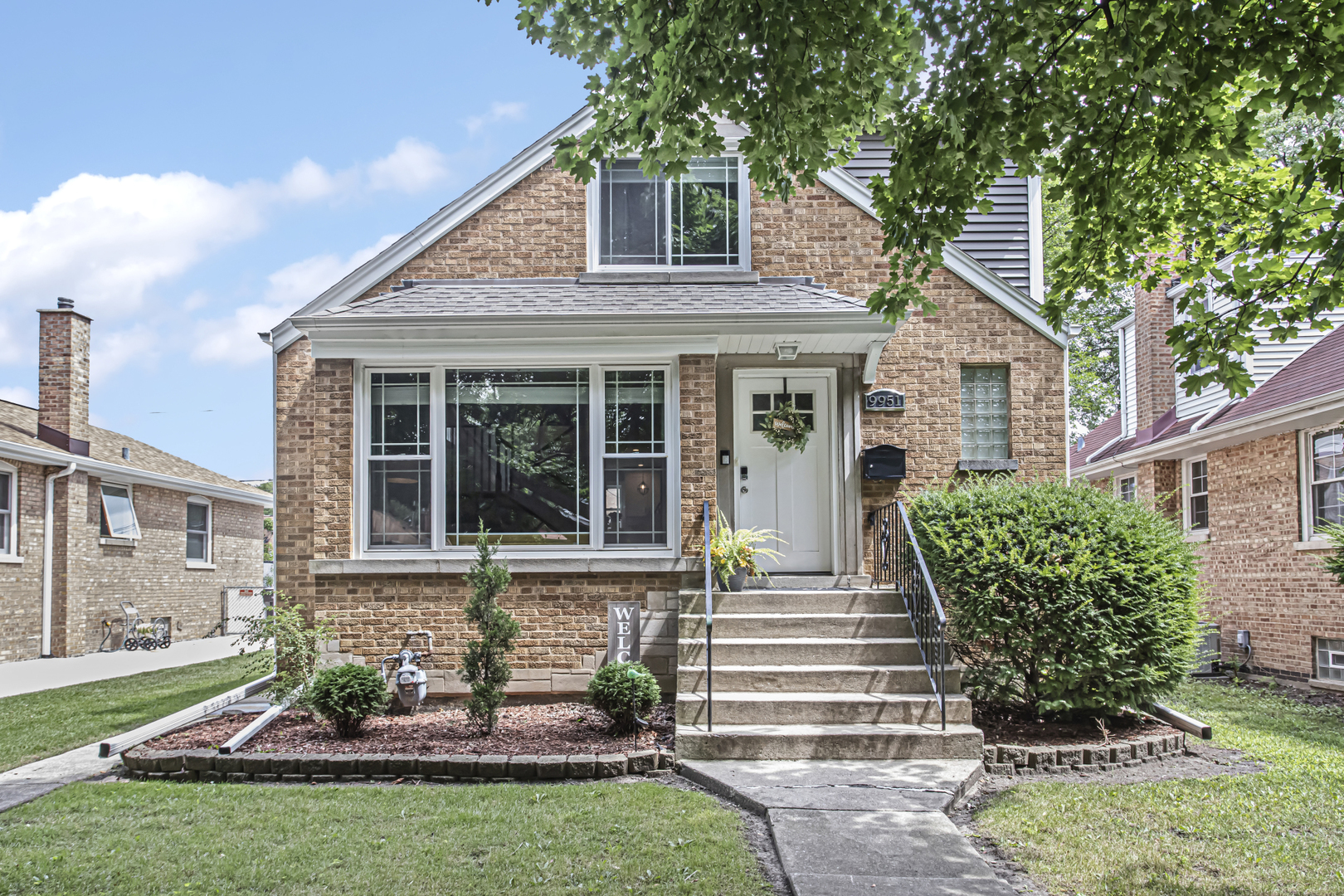 a front view of a house with garden