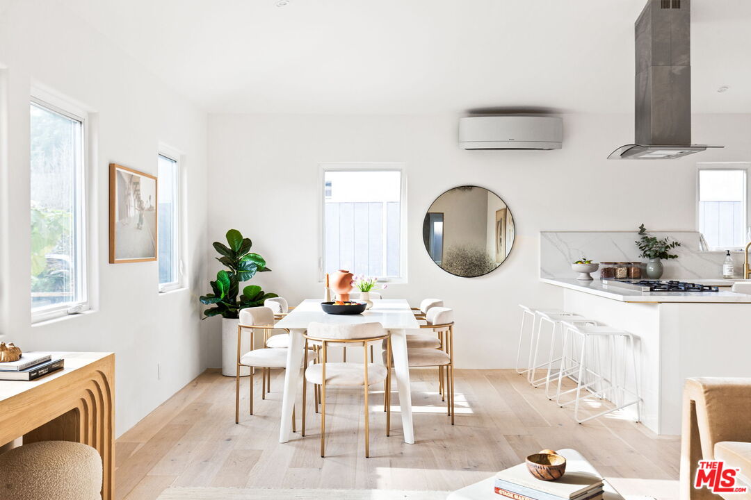 a living room with furniture a mirror and a potted plant