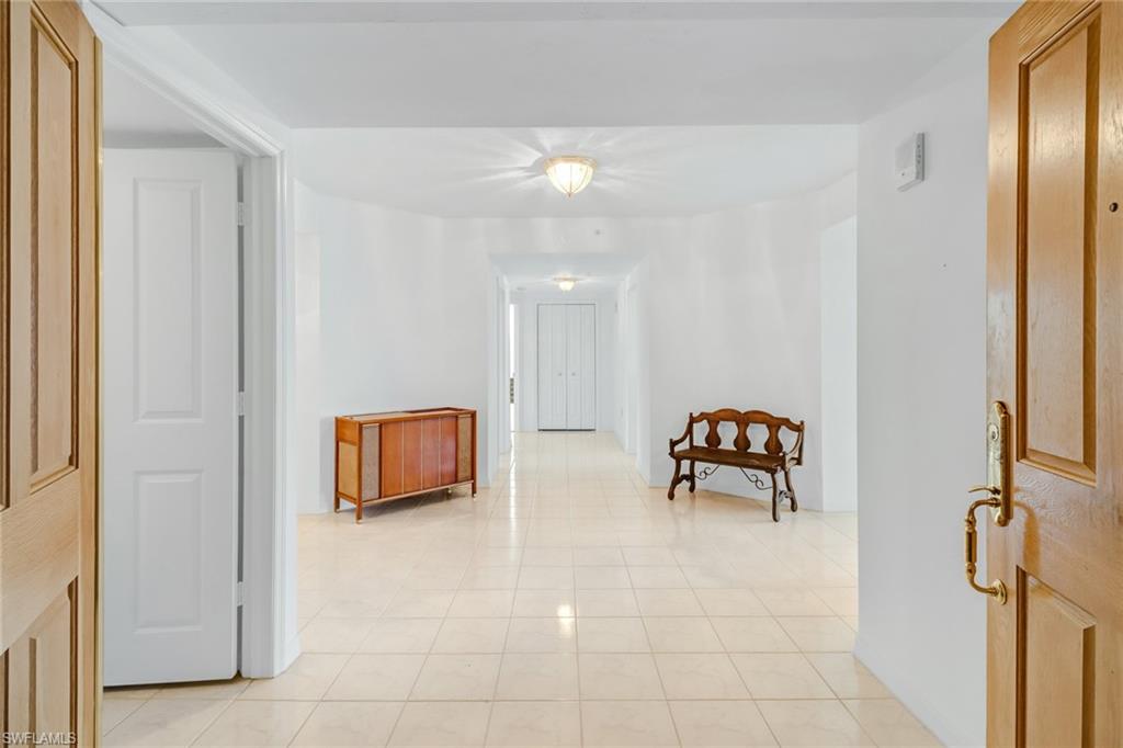 Corridor featuring light tile patterned floors