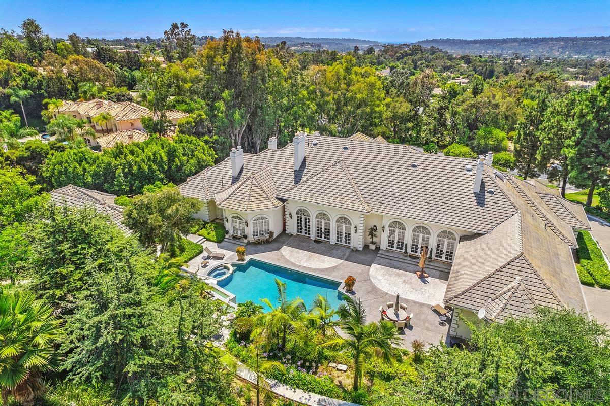 an aerial view of a house with a yard and lake view