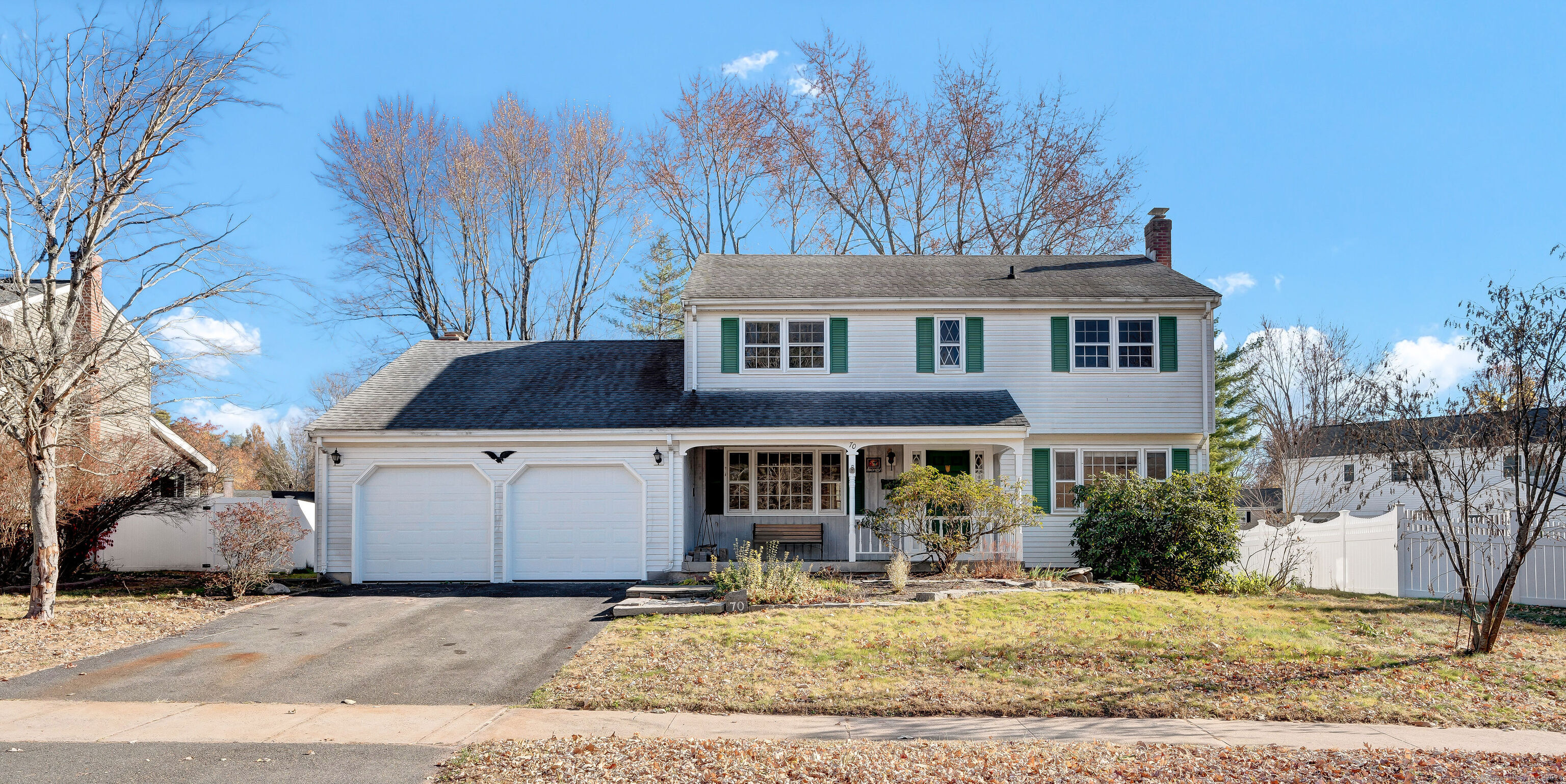 a front view of a house with garden space and yard