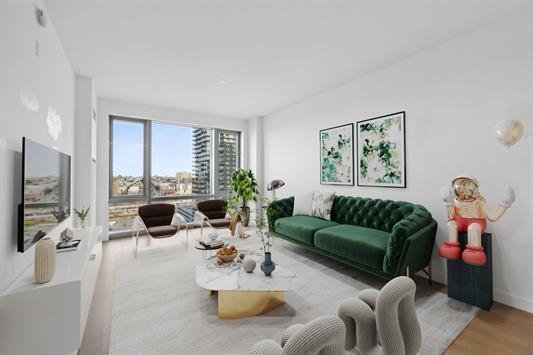 a living room with furniture flat screen tv and a large window