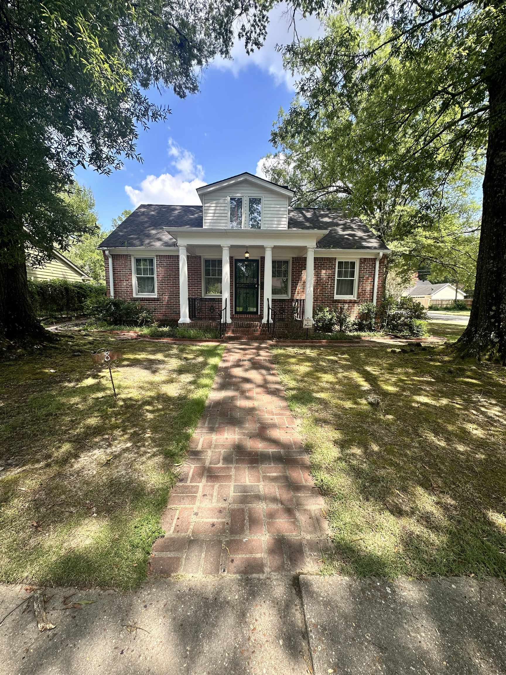 a front view of a house with a garden