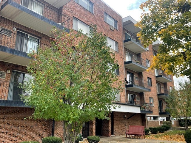 a front view of a building with a garden