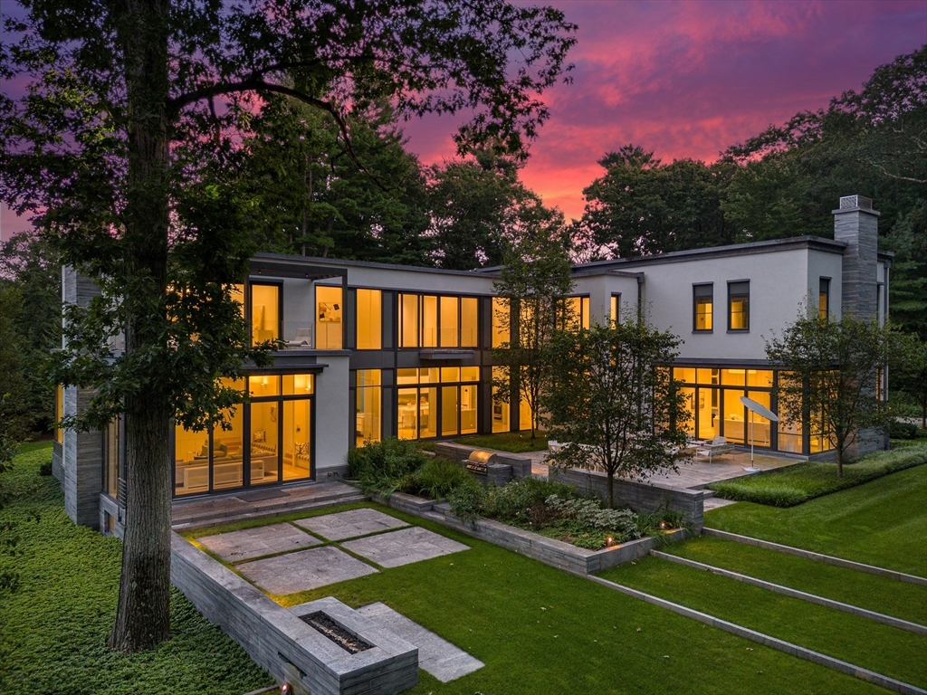 a view of house with backyard and a garden