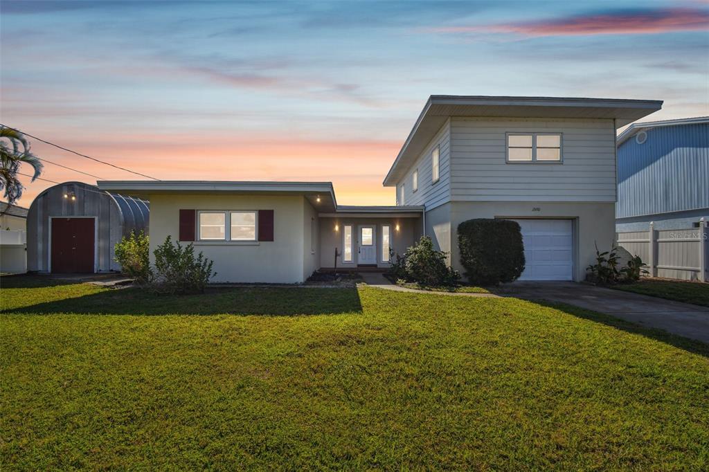 a front view of house with yard and green space