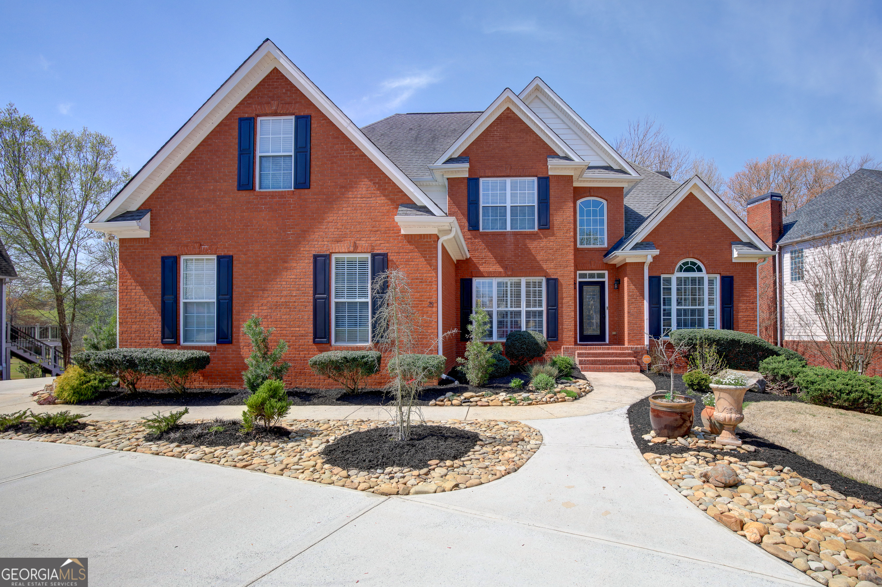 a front view of a house with yard and green space