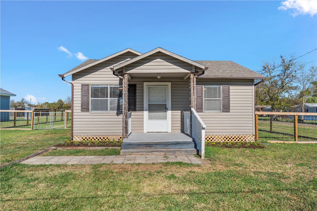 Bungalow-style home with a front yard