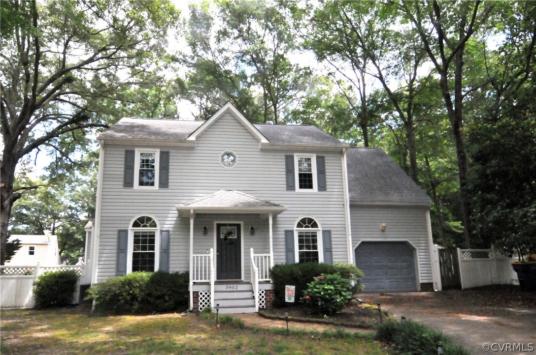 a front view of a house with a yard garage and outdoor seating