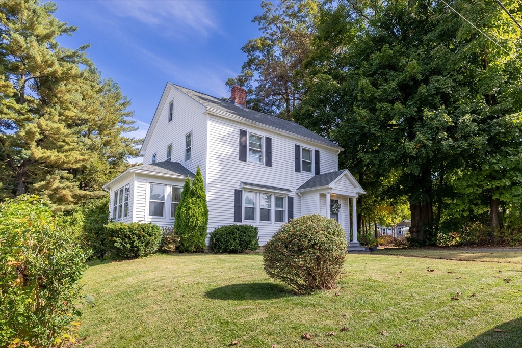 a view of a house with a tree in the yard