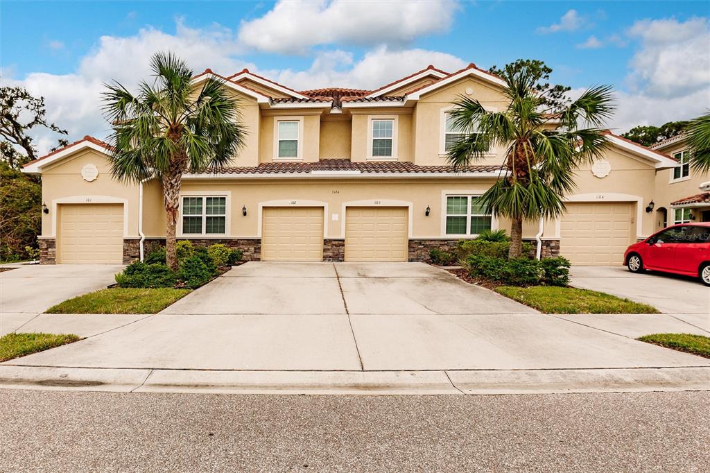 a front view of a house with a yard and garage