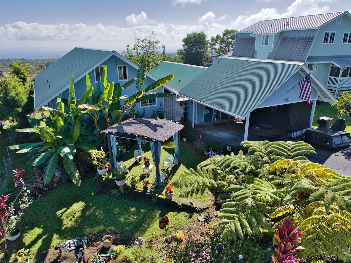 a view of a house with a yard and garden