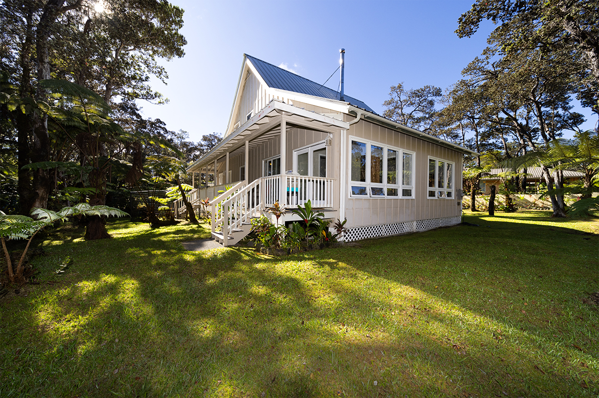 a front view of a house with swimming pool having outdoor seating