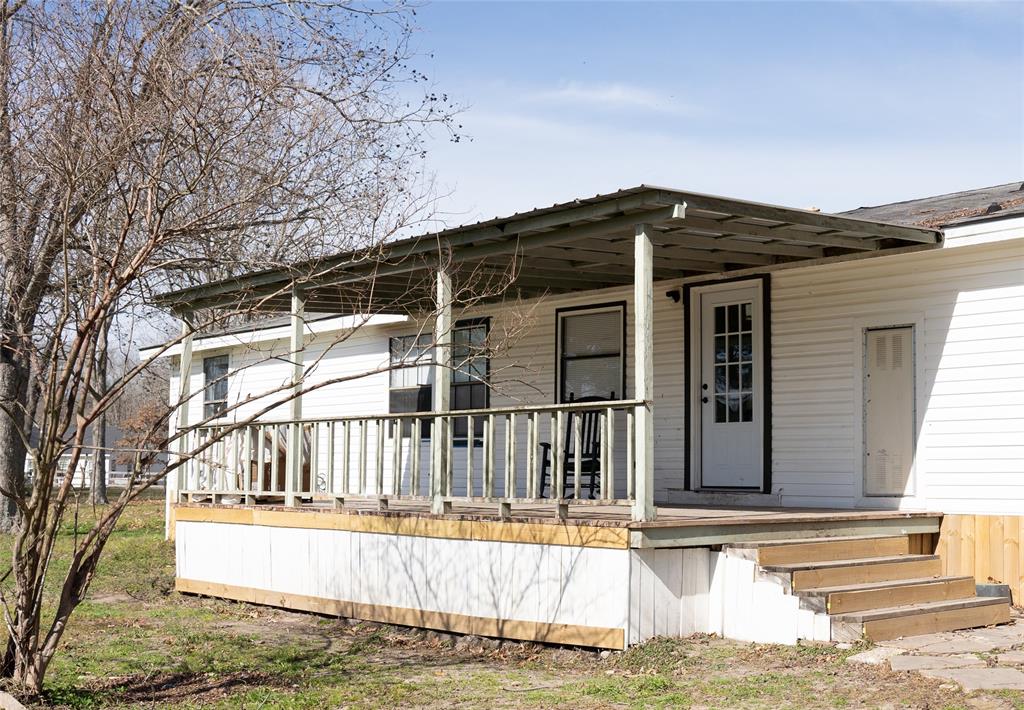 a view of a house with a small yard and wooden fence