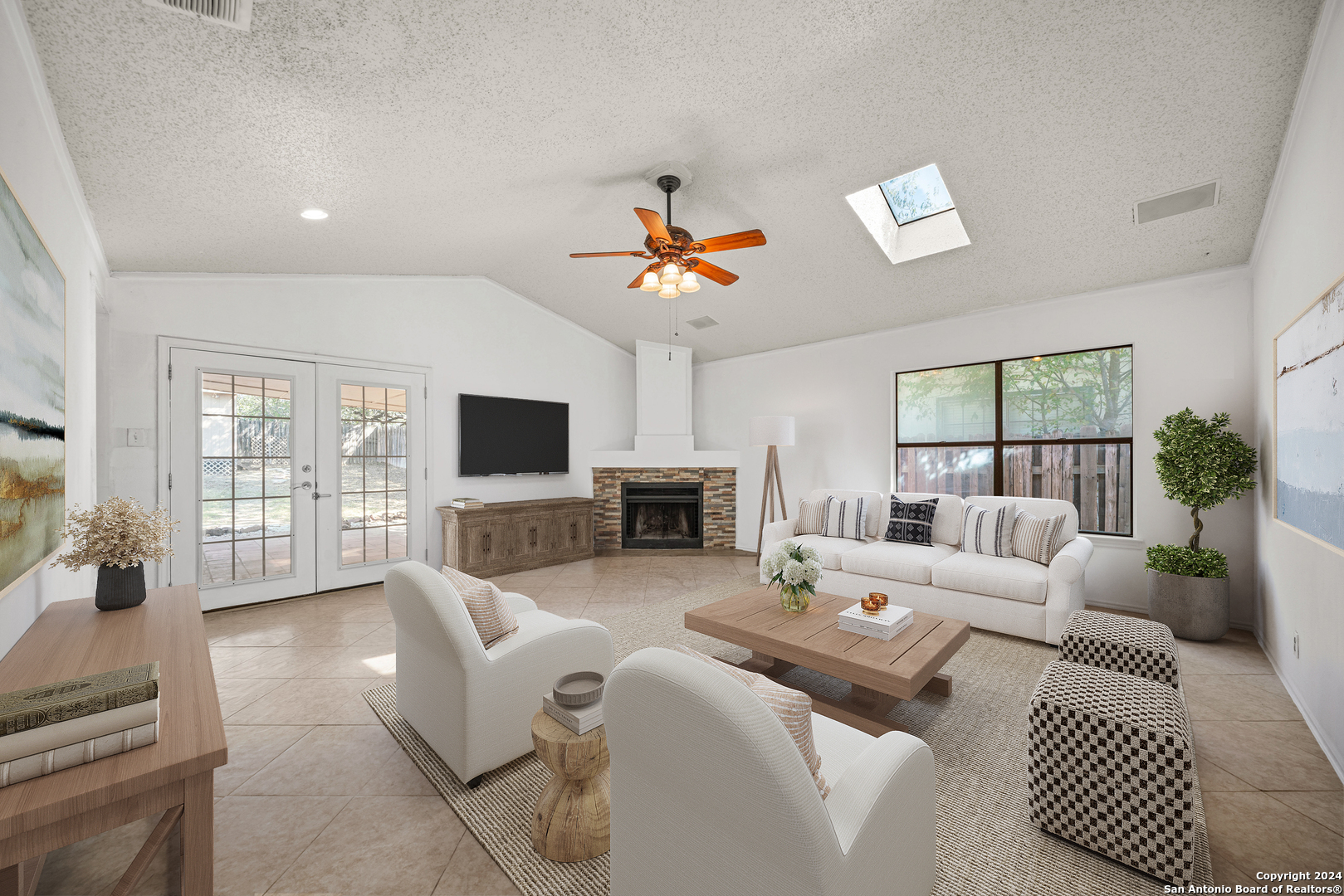 a living room with furniture a flat screen tv and a fireplace