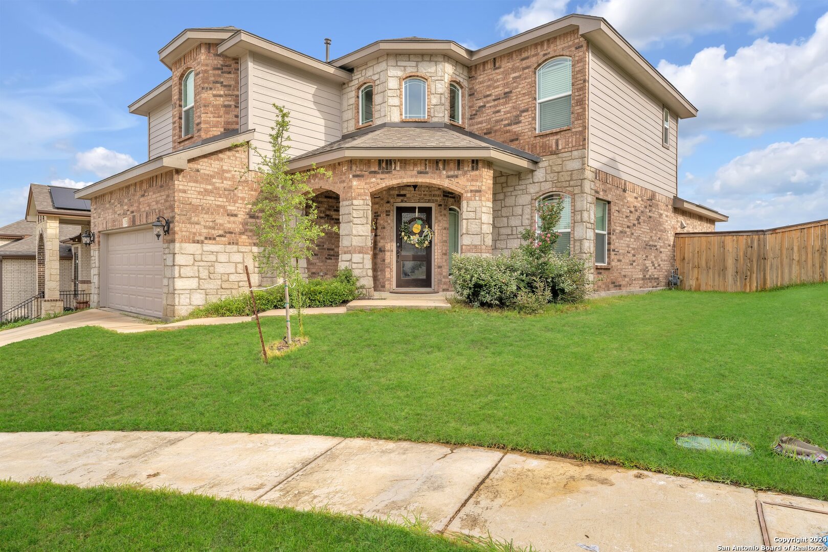 a front view of a house with a garden