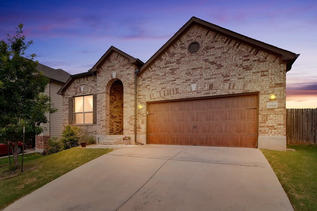 a front view of a house with a yard and garage