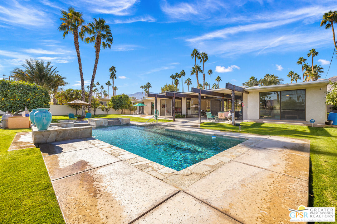 a view of swimming pool with outdoor seating